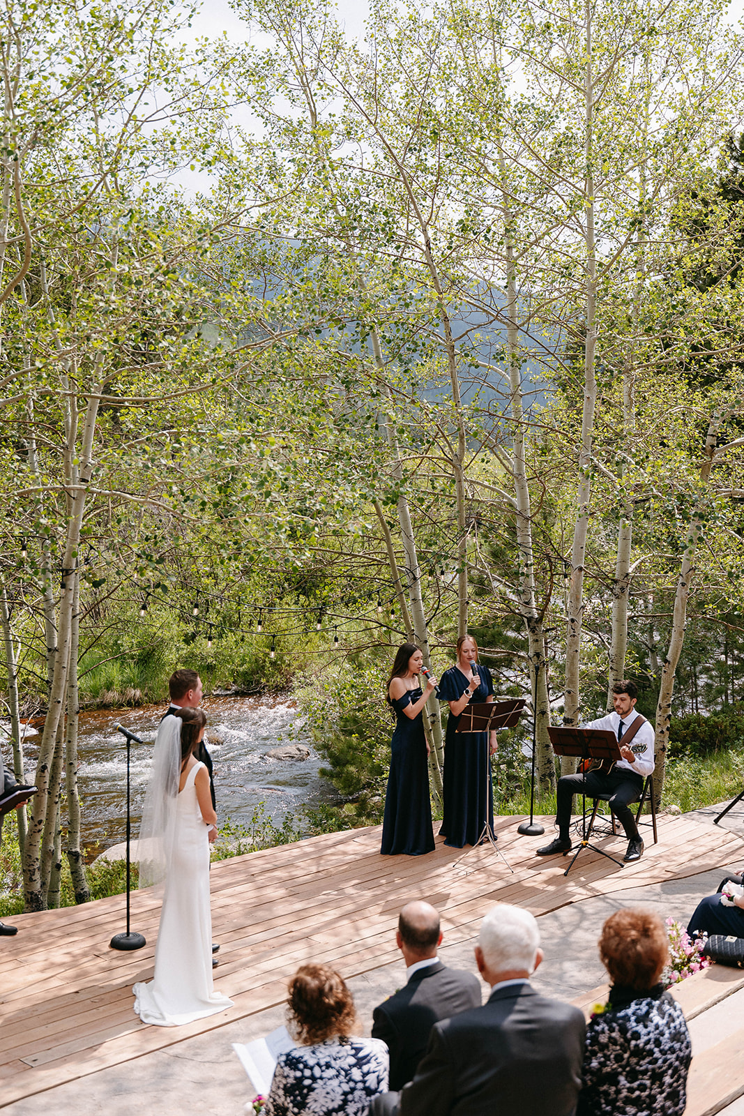 Jason and Amy kissing on the rocks framed by aspen trees